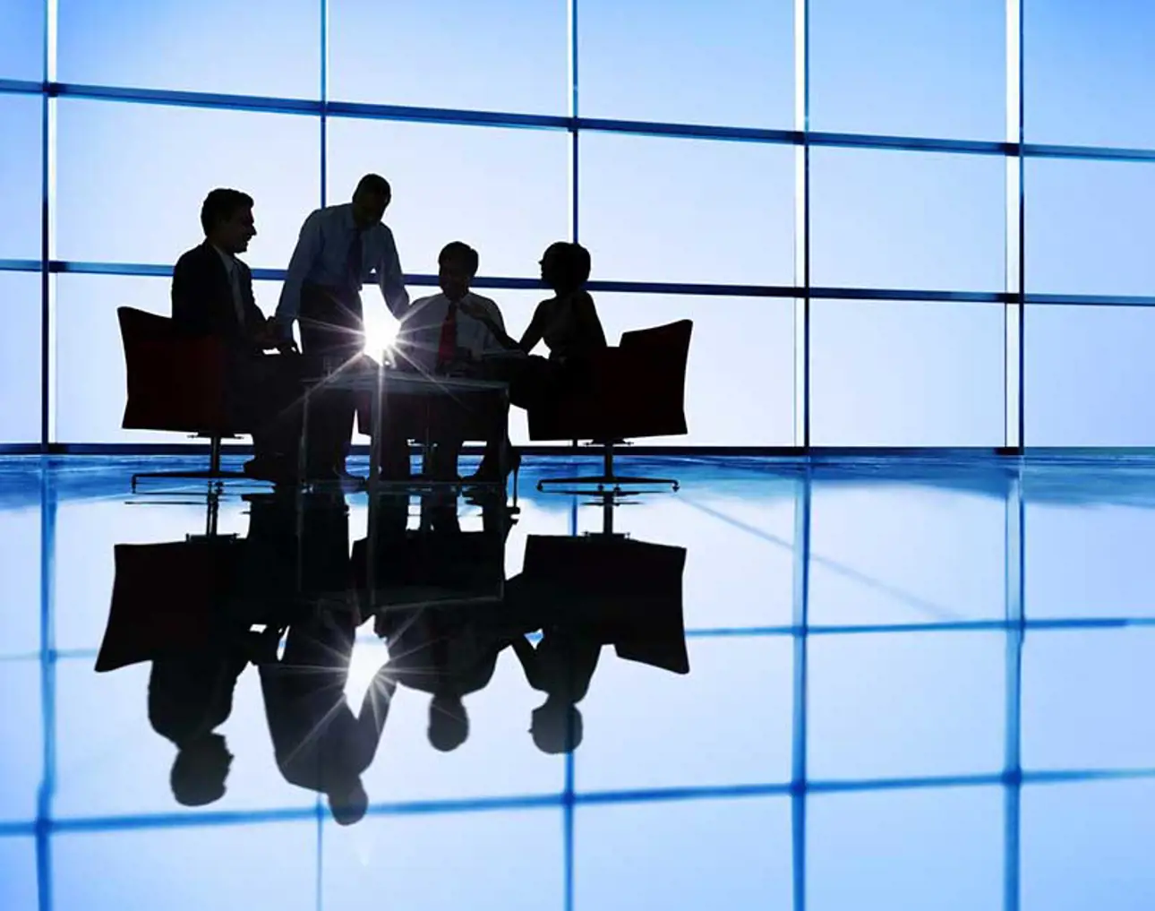 A group of people working in front of big windows