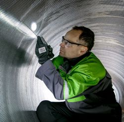 Inspection of suction roll shell by Valmet service engineer