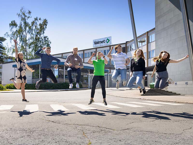 Valmet summer trainees jumping in the air in front of Valmet office in Jyv&auml;skyl&auml;, Finland.